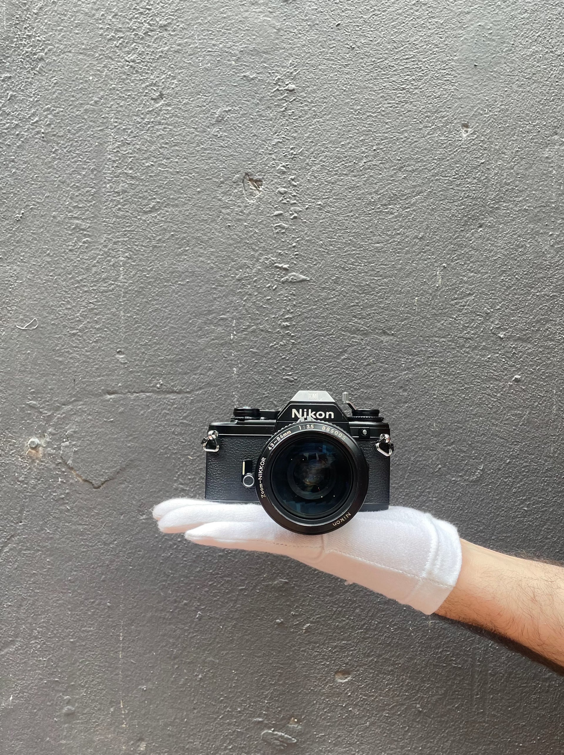 Nikon EM SLR camera with zoom nikkor 43-86mm f/ 1:35 lens