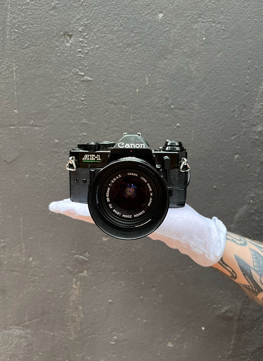 Canon AE-1 Program SLR Camera with Canon FD 28-55mm f/3.5-4.5 Zoom Lens - 1272824H